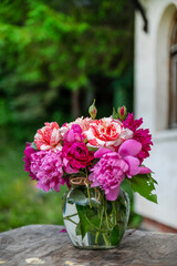 Beautiful bouquet of summer peonies flowers in a glass vase 