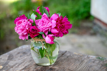 Beautiful bouquet of summer peonies flowers in a glass vase 