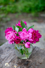 Beautiful bouquet of summer peonies flowers in a glass vase 