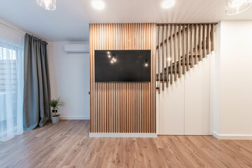 Luxury Living Room Interior. Modern Wide TV Screen. Wooden Stairs, LED Light on the Ceiling.