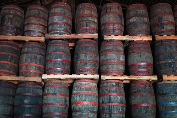 Stacked Wooden Barrels in Warehouse.