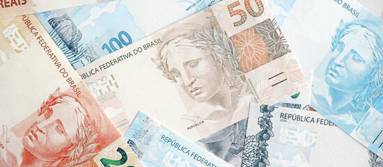 Brazilian reais banknotes. The current Brazil real money bills lies on table in big amount