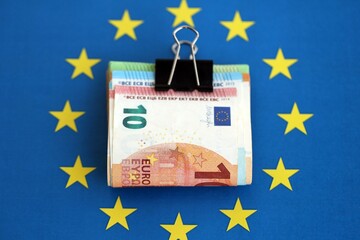 European euro currency money notes bunch on Europe union blue flag close up