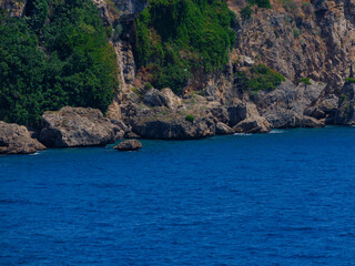 Naklejka premium Rocky coastline with blue sea view