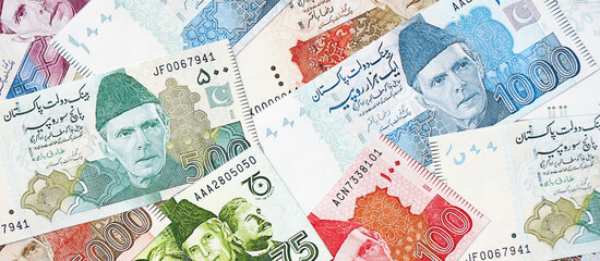 Pakistan rupees banknotes. The current Pakistan money bills lies on table in big amount