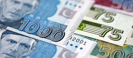 Pakistan rupees banknotes close up. The current Pakistan money bills lies on table in big amount