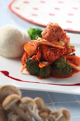 A unique Korean salad using Hericium erinaceus (lions mane mushroom) mixed with broccoli and vegetables in a spicy sauce. A creative dish by master chef Hanshunseop. Photographed in Korea. © HYOJIN