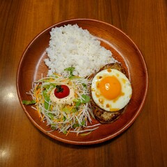 Loco Moco Plate with Rice, Fried Egg, and Salad on a Wooden Table Surface
