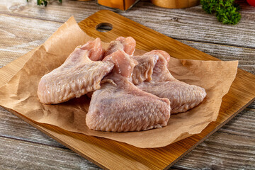 Fresh raw chicken wings over board