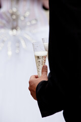 A man is holding a glass of champagne