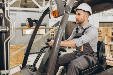 Warehouse worker driving forklift in modular building industry