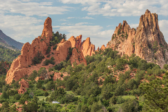 Garden Of the Gods is a National Natural Landmark located in Colorado. Here is pictured a vehicle driving through it. 