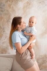 mother and baby, mother gently kisses and hugs her child at home, mother's love and care