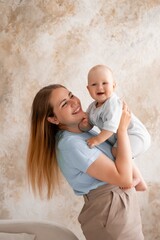 mother and baby, mother gently kisses and hugs her child at home, mother's love and care