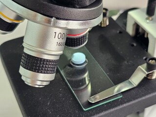 Microscope close-up with chemotherapy antibiotic pills and vitamins concept