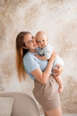 mother and baby, mother gently kisses and hugs her child at home, mother's love and care