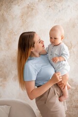 mother and baby, mother gently kisses and hugs her child at home, mother's love and care