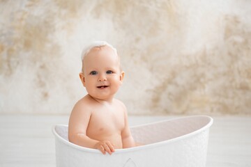 baby in the bathtub, boy bathing or washing in a bathtub with bath foam, baby's hygiene.