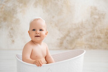 baby in the bathtub, boy bathing or washing in a bathtub with bath foam, baby's hygiene.