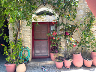 Mesta medieval village. Chios Island, Greece. Flower pots at the entrance of a traditional...