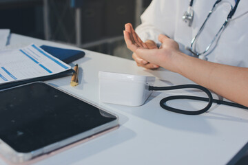 Doctor checking patient arterial blood pressure in hospital. Health care Concept