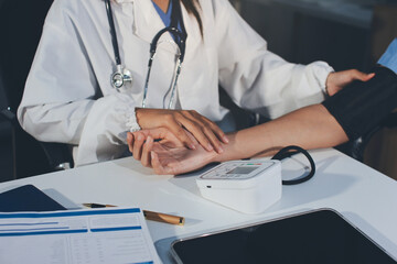 Doctor checking patient arterial blood pressure in hospital. Health care Concept