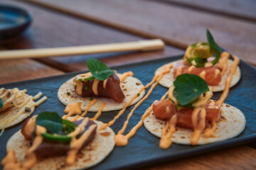Deliciously Crafted Tacos with Fresh Ingredients and Creamy Sauce on a Slate Platter Showcasing...