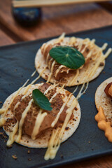 Delicious Gourmet Dish Featuring Unique Ingredients on Soft Tortillas with Creamy Sauce and Fresh Herb Garnish for an Exquisite Culinary Experience