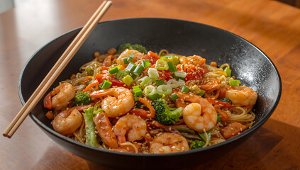 Fototapeta premium Asian stir-fry with shrimp, colorful vegetables, and noodles