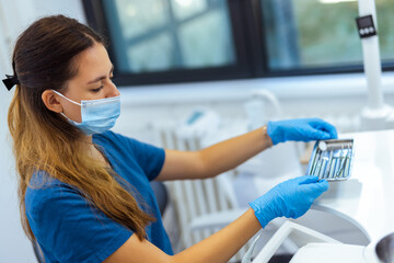 Female Dentist Preparing Tools for Work