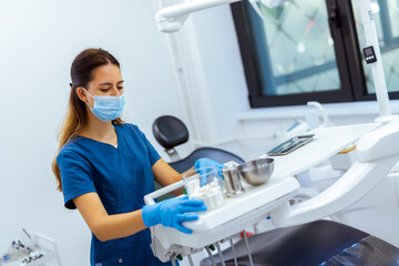 Female Dentist Preparing Tools for Work