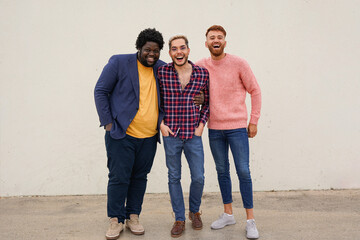 Group of happy diverse men lauging in front of camera - Multiracial male friendship and lifestyle...