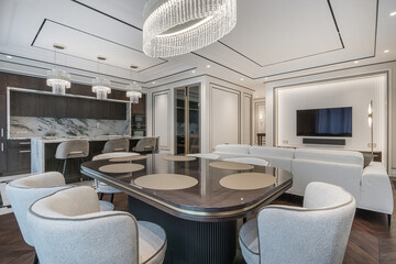 Modern open-plan interior design in neoclassical style. The stylish dining area with elegant...