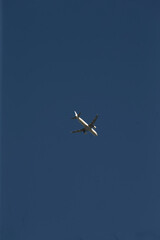 A plane is soaring gracefully through a vast and clear blue sky, showcasing the beauty of aviation and air travel
