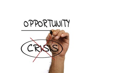 Hand Writing 'Opportunity' and 'Crisis' Representing Positive Change and Growth