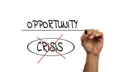 Hand Writing 'Opportunity' and 'Crisis' Representing Positive Change and Growth