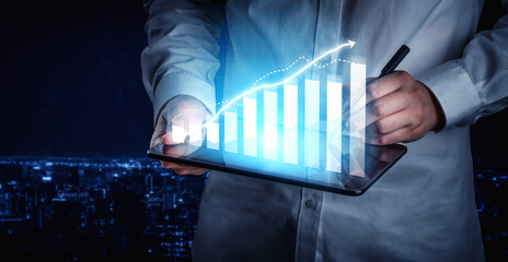 Business professional analyzes financial growth using a digital tablet, showcasing graphs and data...