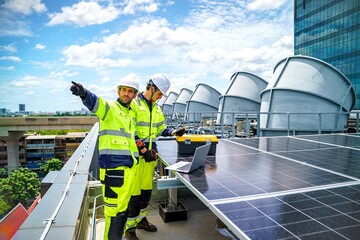 Workers install solar panels on a rooftop under a sunny sky in an urban setting