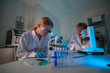 Scientists conducting research in a modern laboratory during evening hours