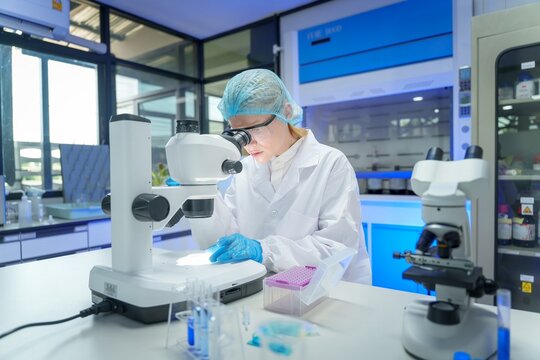 Scientist conducts detailed analysis using microscope in a modern laboratory setting