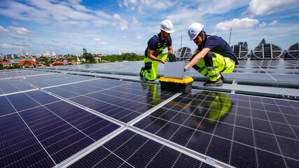 Workers install solar panels on a rooftop in a city during a sunny day