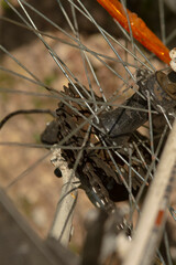 This image depicts a closeup view of a bicycle wheel that has a broken spoke, highlighting its intricate components and structure