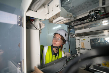 Technician performs maintenance on electronic equipment in a controlled environment