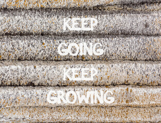 Keep going and growing symbol. Concept words phrase Keep going keep growing on beautiful grey stone wall. Beautiful stone wall background. Business Keep going and growing concept. Copy space.