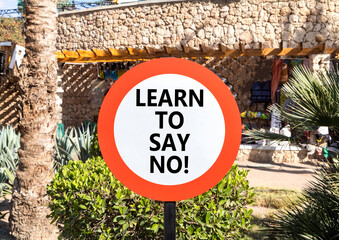 Learn to say no symbol. Concept words phrase Learn to say no on beautiful road sign. Beautiful palm...