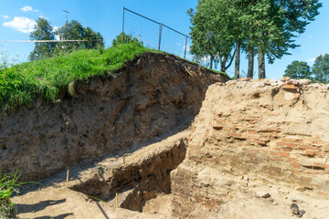 Historical Ruins Unearthed Archaeology Site. Urban Archaeological Excavation Showing Old Brick Wall...