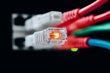 Brightly lit Ethernet cables connected to a network switch, symbolizing internet connectivity, data transfer, technology infrastructure, and the digital world.