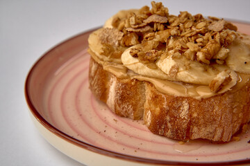 Delicious Toast Topped with Sliced Bananas, Crunchy Granola, and a Drizzle of Honey for a...
