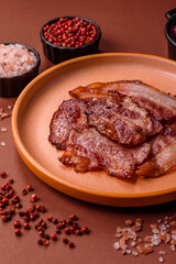Cooked fried crispy bacon as an ingredient of a delicious English breakfast. Pieces of fried bacon