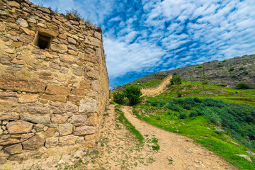 Picturesque mountain landscape with fortification structure and wall of Gunib Russian fortress. Dagestan, Caucasus